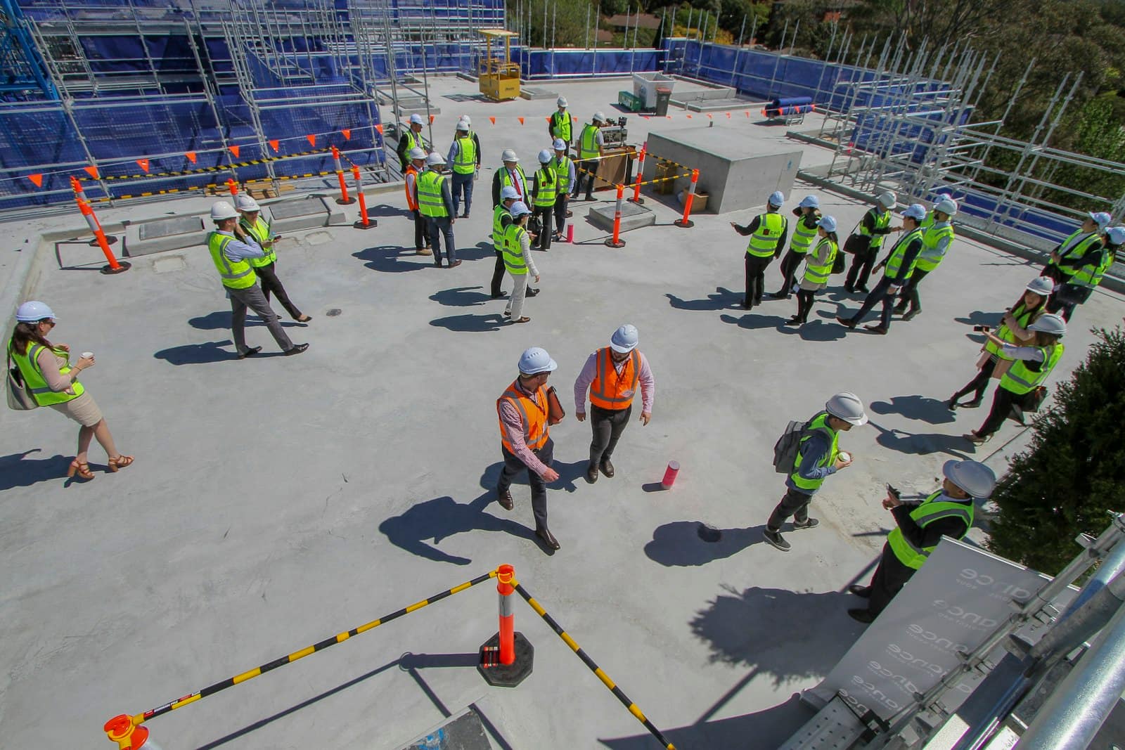 Workers in hi-vis gathered on site for a safety briefing