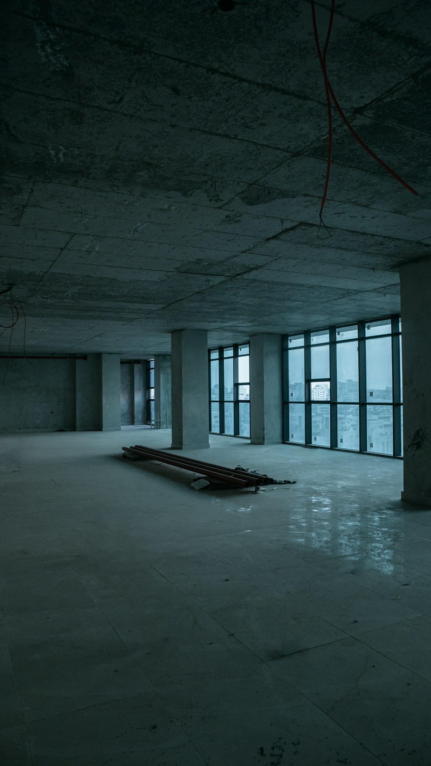 Bare concrete office shell with floor-to-ceiling windows, ready for fit-out