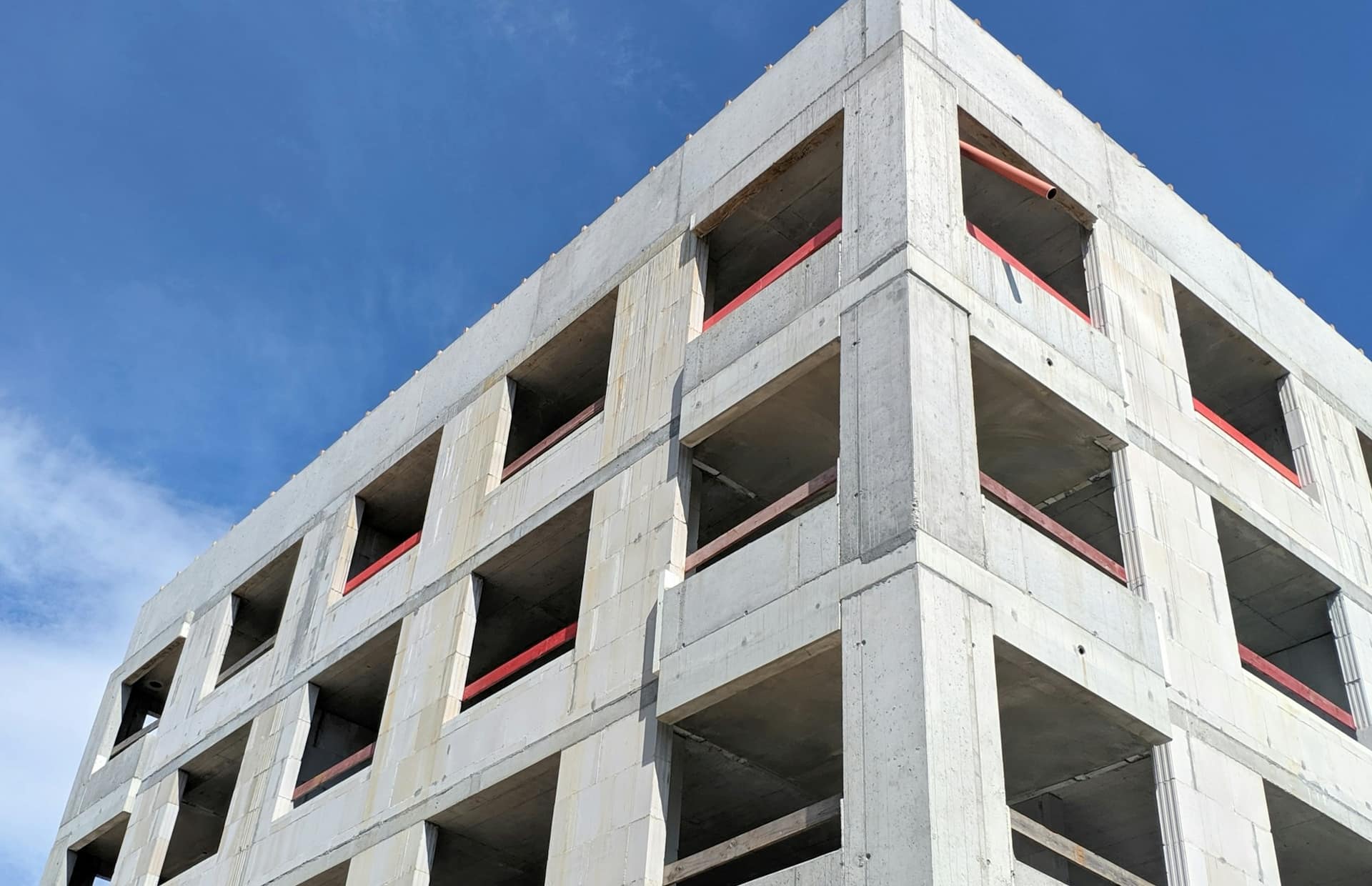 Concrete residential block with open balconies, structure complete