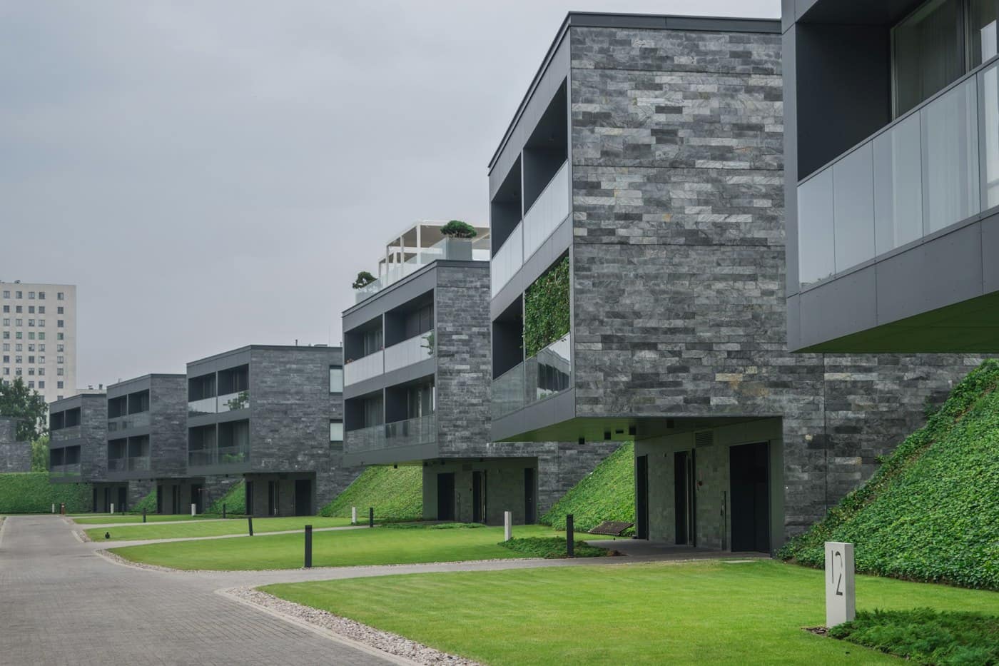 Modern townhouses with stone cladding and a green lawn